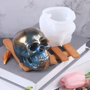 Detailed view of Halloween skull silicone mold with finished metallic blue skull ornament.