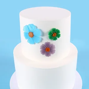 Detail view showing colorful resin sunflower charms arranged on a minimalist white display stand