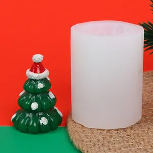 Detail of Christmas tree silicone mold alongside a finished festive green candle