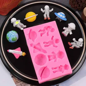 Detailed silicone mold featuring astronaut, rocket, and planet shapes for DIY cake baking