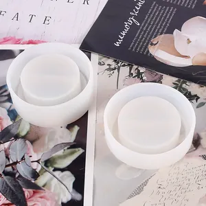 Detailed view of two translucent silicone molds for DIY round resin storage boxes.