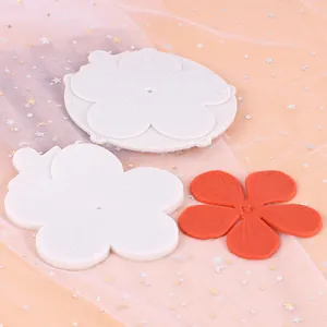 Detailed macro view of silicone flower petal mold with finished fondant petal piece