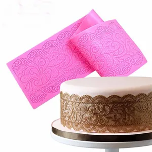 Detailed view of pink silicone lace mold with floral patterns for cake decorating.