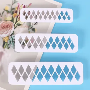 Set of three white geometric rhombus-shaped plastic cutters for DIY biscuit and cake baking.