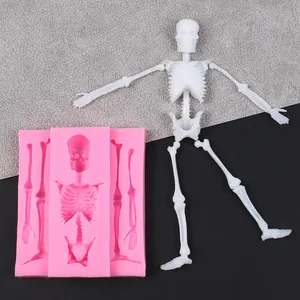 Detailed view of pink silicone skeleton mold showing finished white resin bone parts