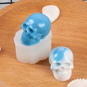 Detailed view of Halloween skull silicone mold with finished resin skull ornaments