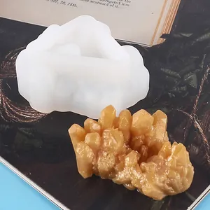 Close-up view of a crystal cluster silicone mold and its finished golden resin piece