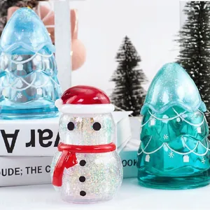 Detailed view of DIY glittery resin Christmas tree and snowman holiday ornaments