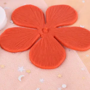 Macro view showing the intricate texture of the orange silicone flower petal mold