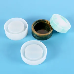 Detailed view of round silicone molds and finished DIY crystal resin storage boxes