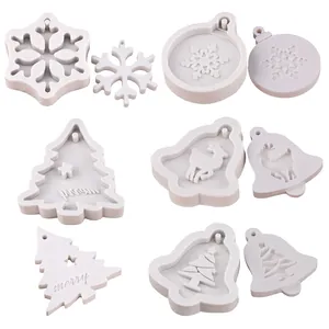 Detail view of snowflake reindeer and merry tree silicone molds for fondant decorating