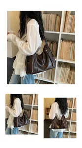 Stylish brown large capacity hobo bag worn by model in a library setting for commuting