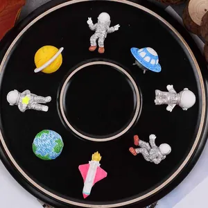 Detailed view of assorted space-themed fondant decorations including astronauts and planets