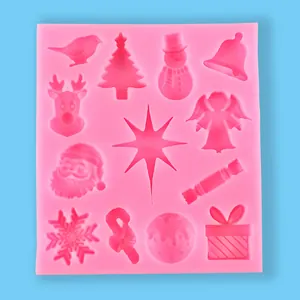 Close-up view of a pink Christmas silicone mold showing Santa and snowflake cavities