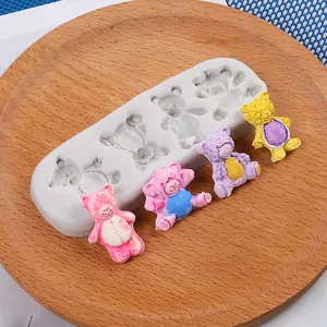 Detailed view of bear silicone mold with colorful finished resin bear figurines.