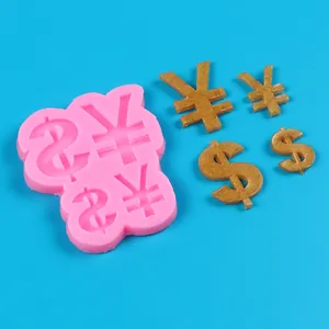 Macro view of pink silicone mold showing dollar and yen symbols with finished gold pieces