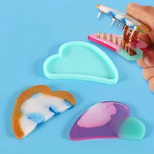 Detail showing heart-shaped silicone mold with finished marble resin hair clip pieces