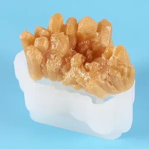 Close-up of DIY crystal cluster silicone mold with golden resin casting details