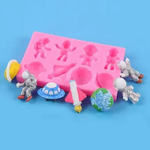 Detail of space-themed silicone mold with astronaut, rocket and UFO shapes for DIY cake