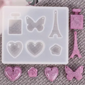 Moule en silicone DIY pour résine avec formes de cœur, papillon et tour Eiffel.