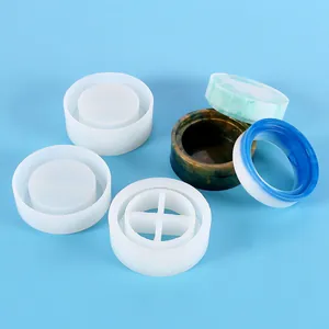 Detailed view of DIY silicone molds for creating circular resin storage boxes and pen holders