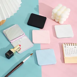 Portable candy-colored double-sided makeup mirrors on a blue and pink background