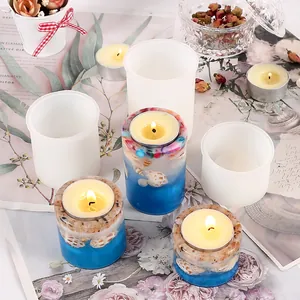 Detailed view of DIY silicone molds and finished epoxy resin candle holders with shells