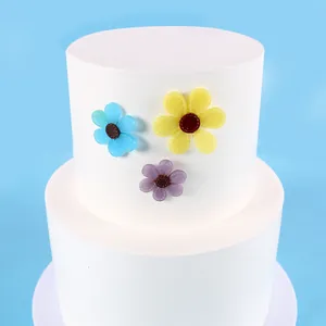 Close-up of colorful resin sunflower charms decorated on a white display stand