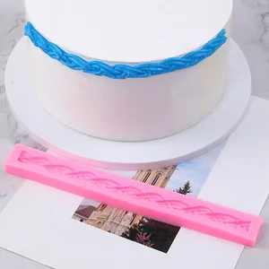 Long pink silicone fondant lace border mold showing braided decorative effect on white cake