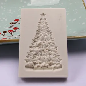Detail view of a white silicone Christmas tree mold with intricate branch and gift patterns.