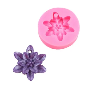 Detail of flower shaped silicone mold and purple resin pendant with hole