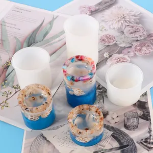 Detail showing translucent silicone molds with finished seashell resin candle holders.