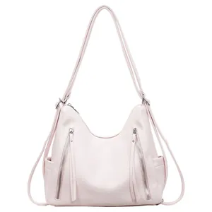 Detailed front view of a large capacity pale pink hobo bag with dual vertical zippers