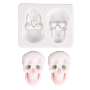 Close-up of a skull silicone mold and finished white fondant skull decorations