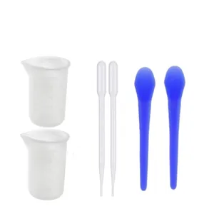 Detail of DIY epoxy resin mixing tool set including measuring cups, pipettes, and blue rods