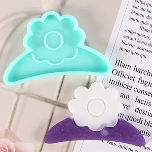 Detail view of a flower hair clip silicone mold and its finished sparkling resin creation.