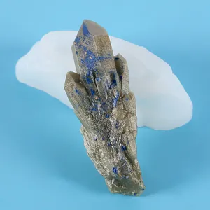 Close-up of a crystal cluster resin piece alongside its translucent silicone DIY mold