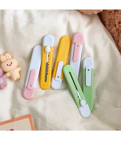 Detailed view of candy-colored mini utility knives in pastel yellow, green and pink