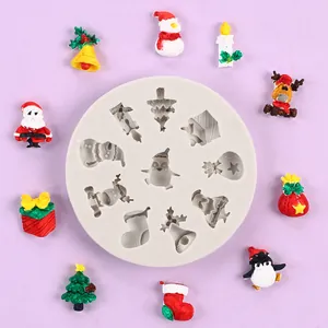 Detailed view of a Christmas silicone mold with finished Santa and penguin resin figures.