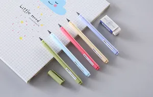 Assorted pastel inkless eternal pencils displayed on a minimal gridded notebook for art