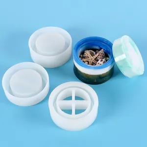 Detailed view of DIY silicone molds and a finished resin storage box with shells.