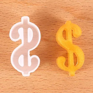 Detailed view of a dollar sign silicone mold next to an orange glitter resin finished craft