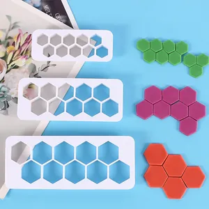 Set of three white plastic hexagon cookie cutters showing various sizes for geometric cake DIY