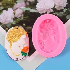 Detailed view of the silicone mold and finished plaster pendant with lady portrait relief.
