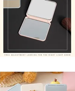 Close-up of a portable folding double-sided makeup mirror with a cute cartoon design