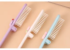 Detail view of portable folding mini hair combs in pastel purple white and light blue colors