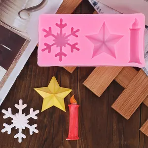 Detailed view of pink Christmas silicone mold with snowflake, star, and candle shapes.