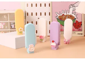 Detailed view of colorful pastel foldable mini hairbrushes with cute cartoon decorations