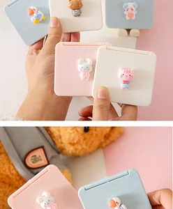 Detail view of cute cartoon mini folding makeup mirrors with colorful 3D animal figures