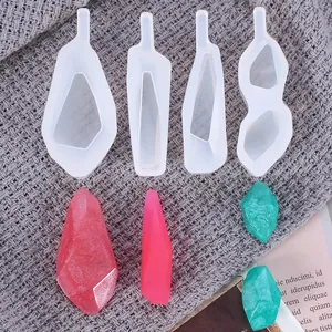 Detail showing four geometric silicone molds with finished colorful resin crystals